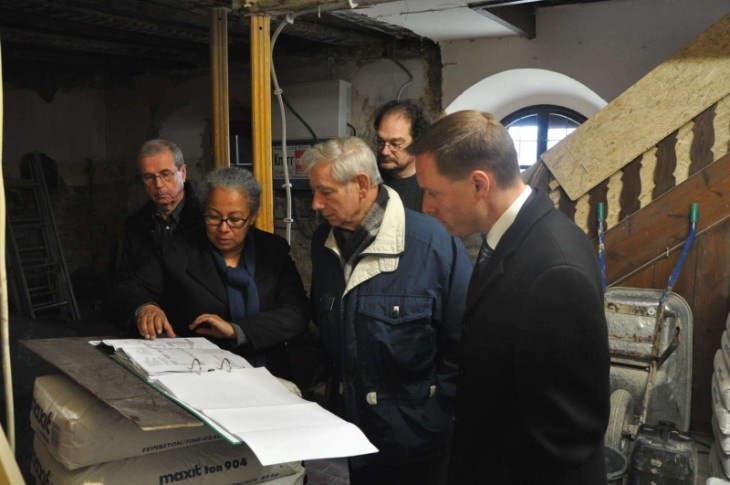 Georg Maul, Vorsitzender des Verschönerungsvereins, Architektin Marisia Conn, Bürgermeister Peter Stief, Restaurator Claus Giersch und Landrat Armin Kroder (v. links) betrachten den Plan des aktuell zu renovierenden Teils der Burg Hohenstein. Foto: Häusler