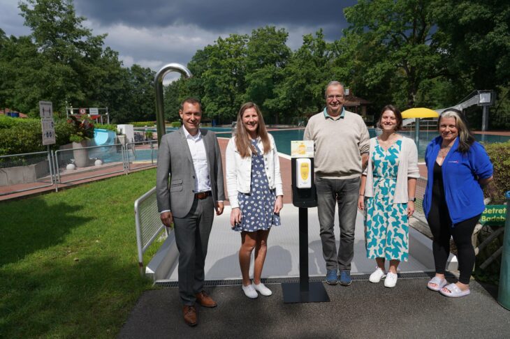 Landrat Armin Kroder, Katharina Eichenmüller von der GesundheitsregionPlus, Dr. Uwe Drochner und Christin Lind vom Staatlichen Gesundheitsamt mit Christina Bazzanella, Betriebsleitung des Laufer Freibads, und dem neuen Sonnenmilchspender (von links).