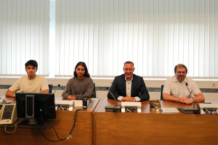 Mateo Sebastian Castro Ramos, Julia Donoso, Landrat Armin Kroder und Lehrer Alexander Trinkmann im großen Sitzungssaal des Landratsamts.