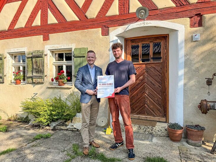 Bezirkstagspräsident Peter Daniel Forster (links) überreicht auf dem Engelthaler Gut den Förderbescheid über 15.000 Euro zur Förderung der Denkmalpflege an Johannes Felgner.