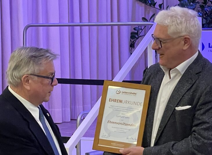 Jürgen Six (rechts) überreicht seinem Vorgänger Gerhard John die Urkunde, mit der er zum Ehrenvorsitzenden der Lebenshilfe wird.