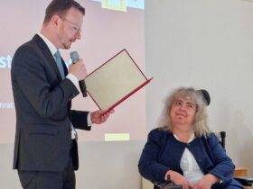 Bezirkstagspräsident Peter Daniel Forster überreicht den Ehrenbrief des Bezirks Mittelfranken im Jüdischen Museum Franken in Fürth an Angelika Feisthammel.
