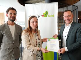 Landrat Armin Kroder (rechts) übergibt die Umweltpakt-Urkunde an Stefanie Bezold und Oliver Fürsattel (beide Abteilung Umweltschutz und Arbeitssicherheit Excella GmbH & Co. KG).
