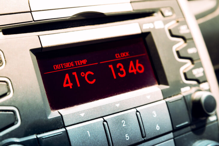 Summer hot temperatures. High temperature on car dashboard display.