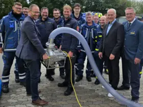 Vertreter der Sparkasse und des THW freuen sich über die beiden neuen Hochleistungsschmutzwasserpumpen.